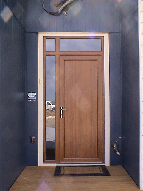 gallery image - wooden looking entrance door with glass panels